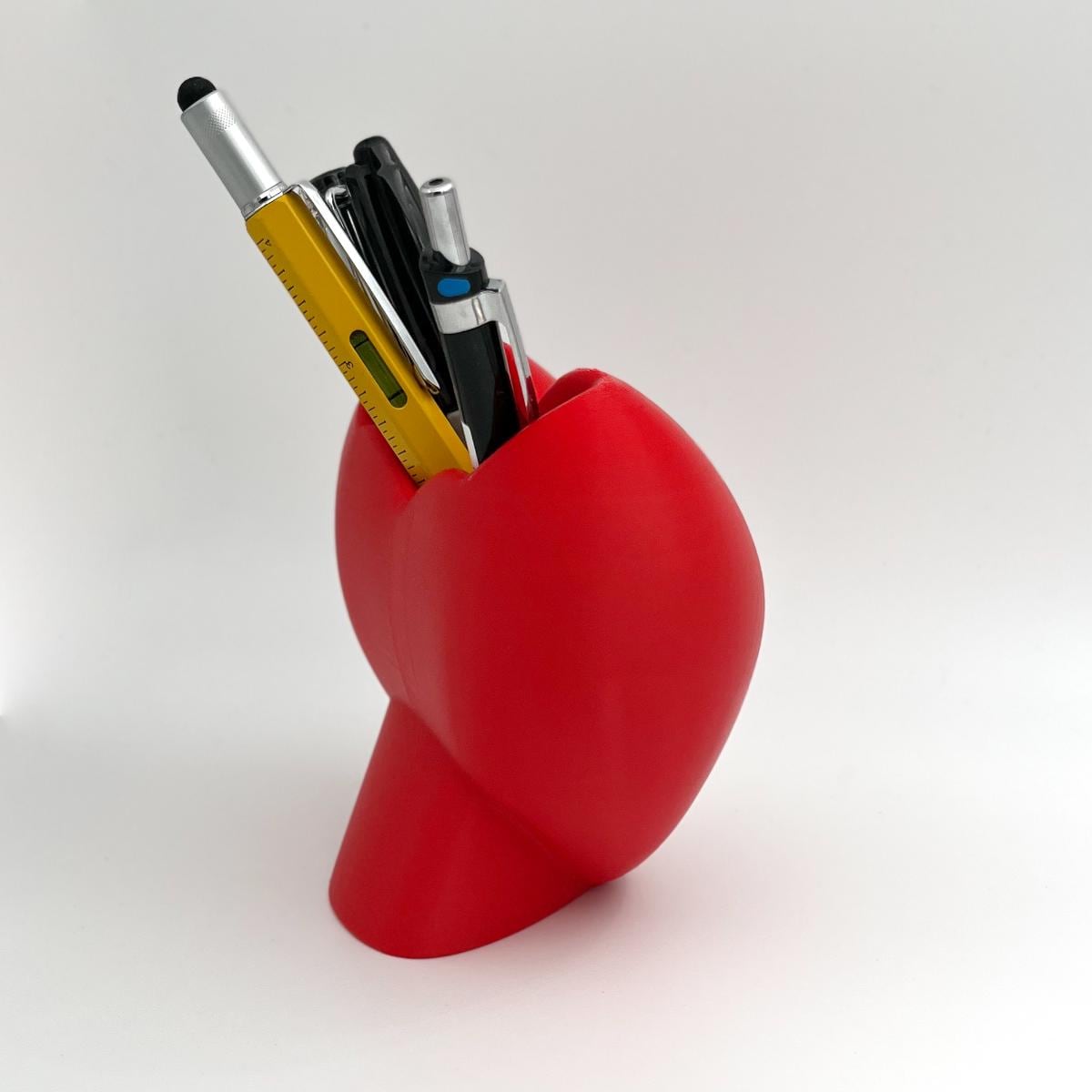Heart shaped desktop storage pot. A vase for a few flowers or a place to keep makeup brushes, pens or pencils.