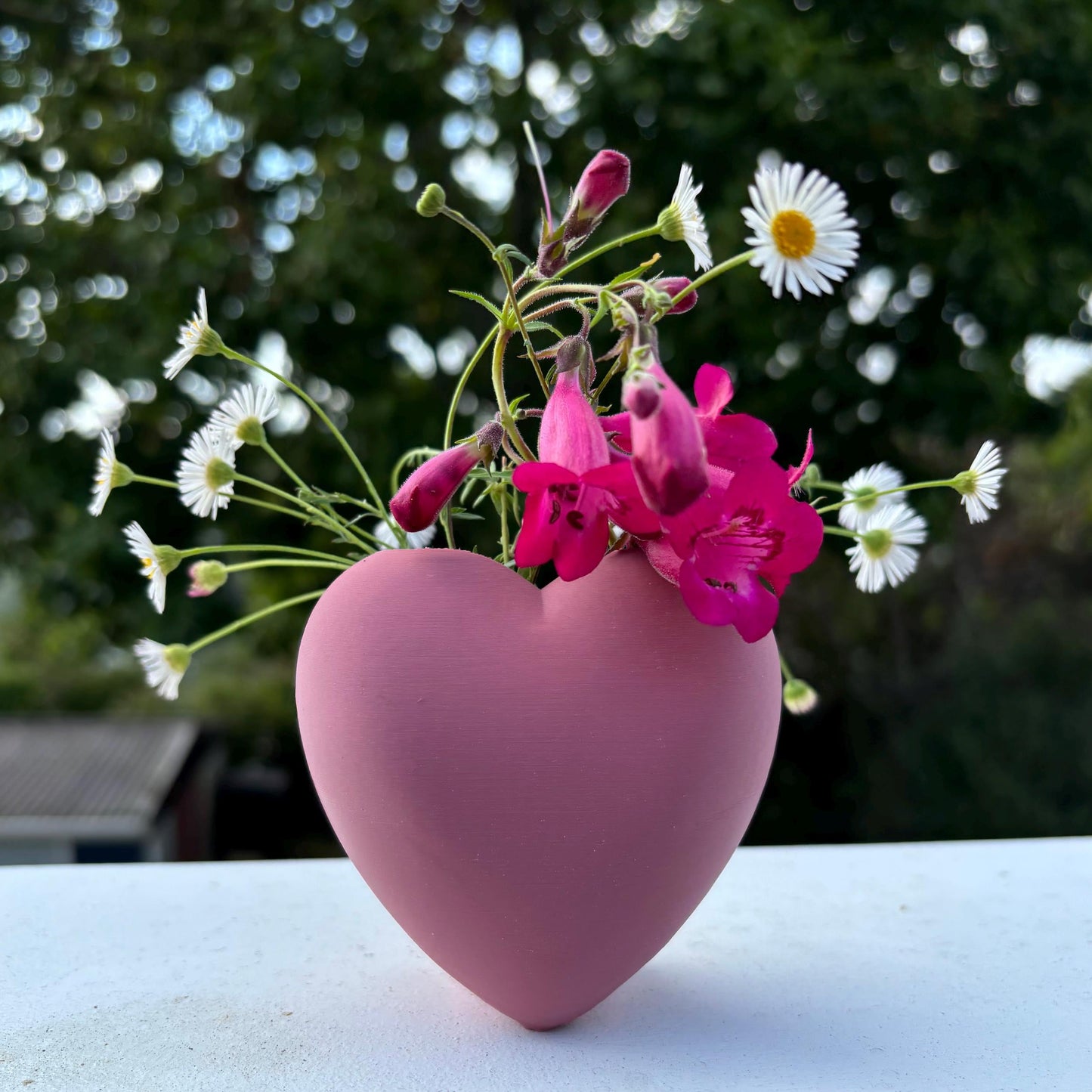 Heart shaped desktop storage pot. A vase for a few flowers or a place to keep makeup brushes, pens or pencils.