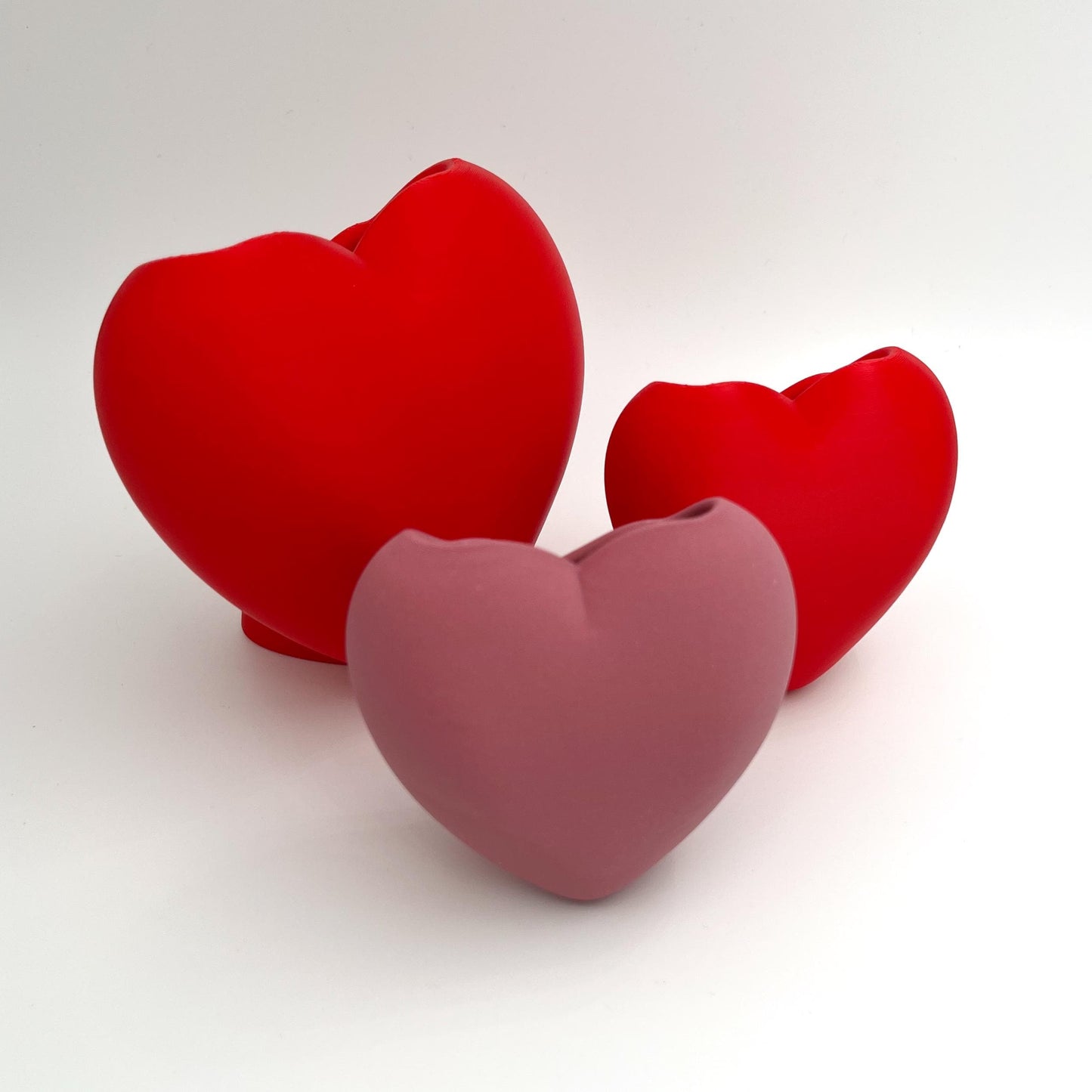 Heart shaped desktop storage pot. A vase for a few flowers or a place to keep makeup brushes, pens or pencils.