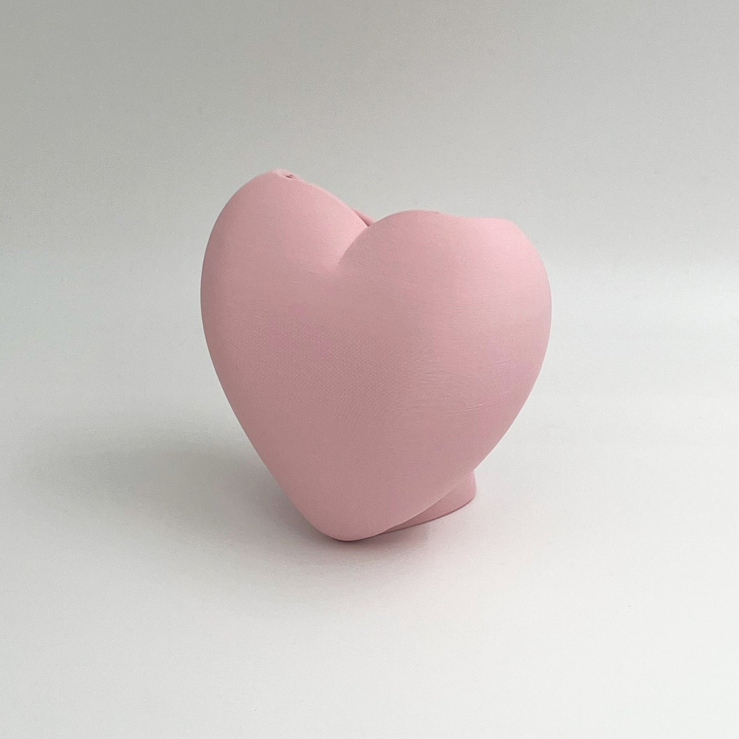 Heart shaped desktop storage pot. A vase for a few flowers or a place to keep makeup brushes, pens or pencils.