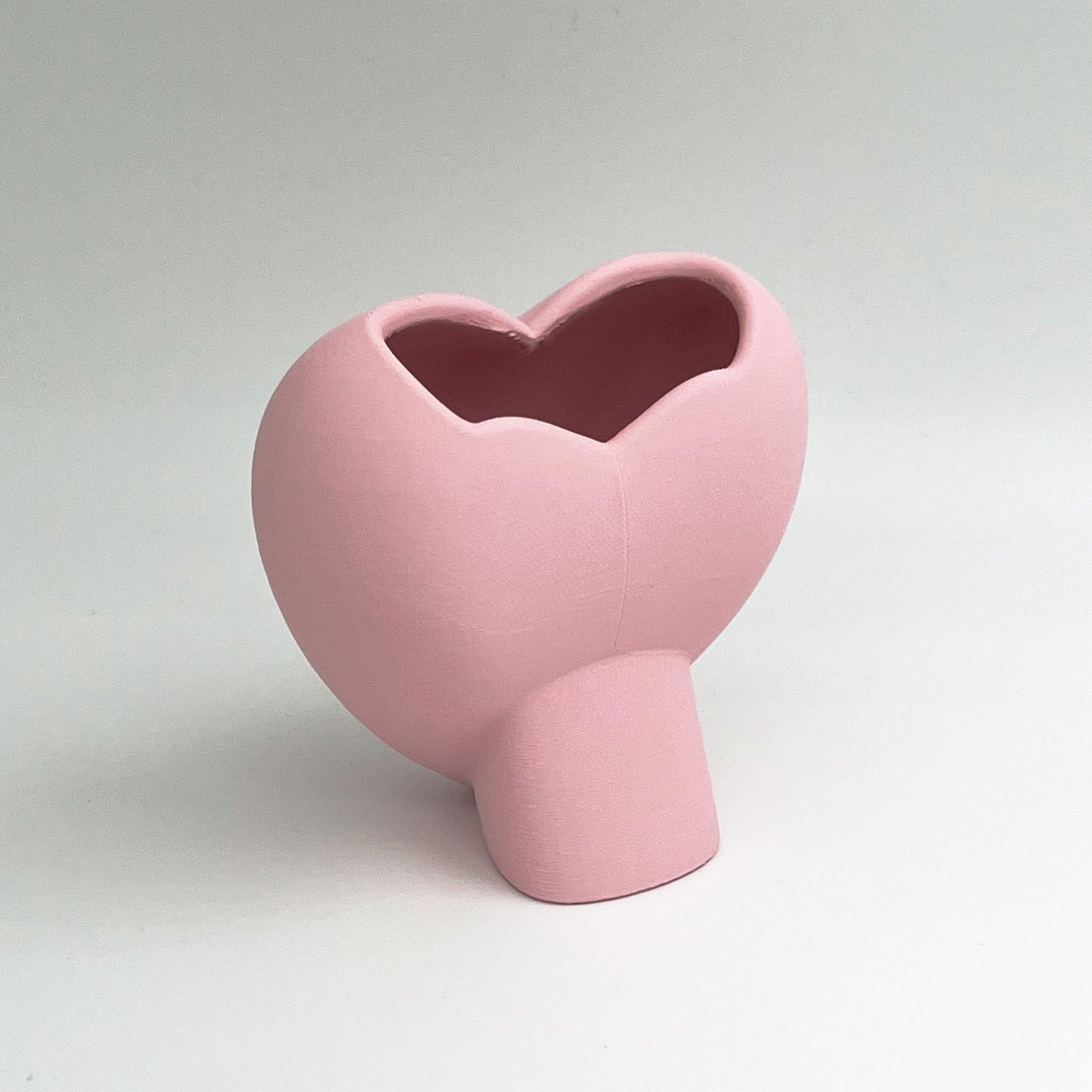 Heart shaped desktop storage pot. A vase for a few flowers or a place to keep makeup brushes, pens or pencils.