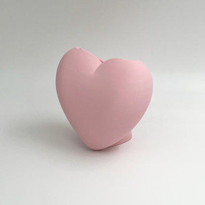 Heart shaped desktop storage pot. A vase for a few flowers or a place to keep makeup brushes, pens or pencils.