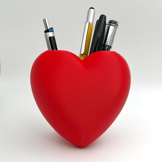 Heart shaped desktop storage pot. A vase for a few flowers or a place to keep makeup brushes, pens or pencils.